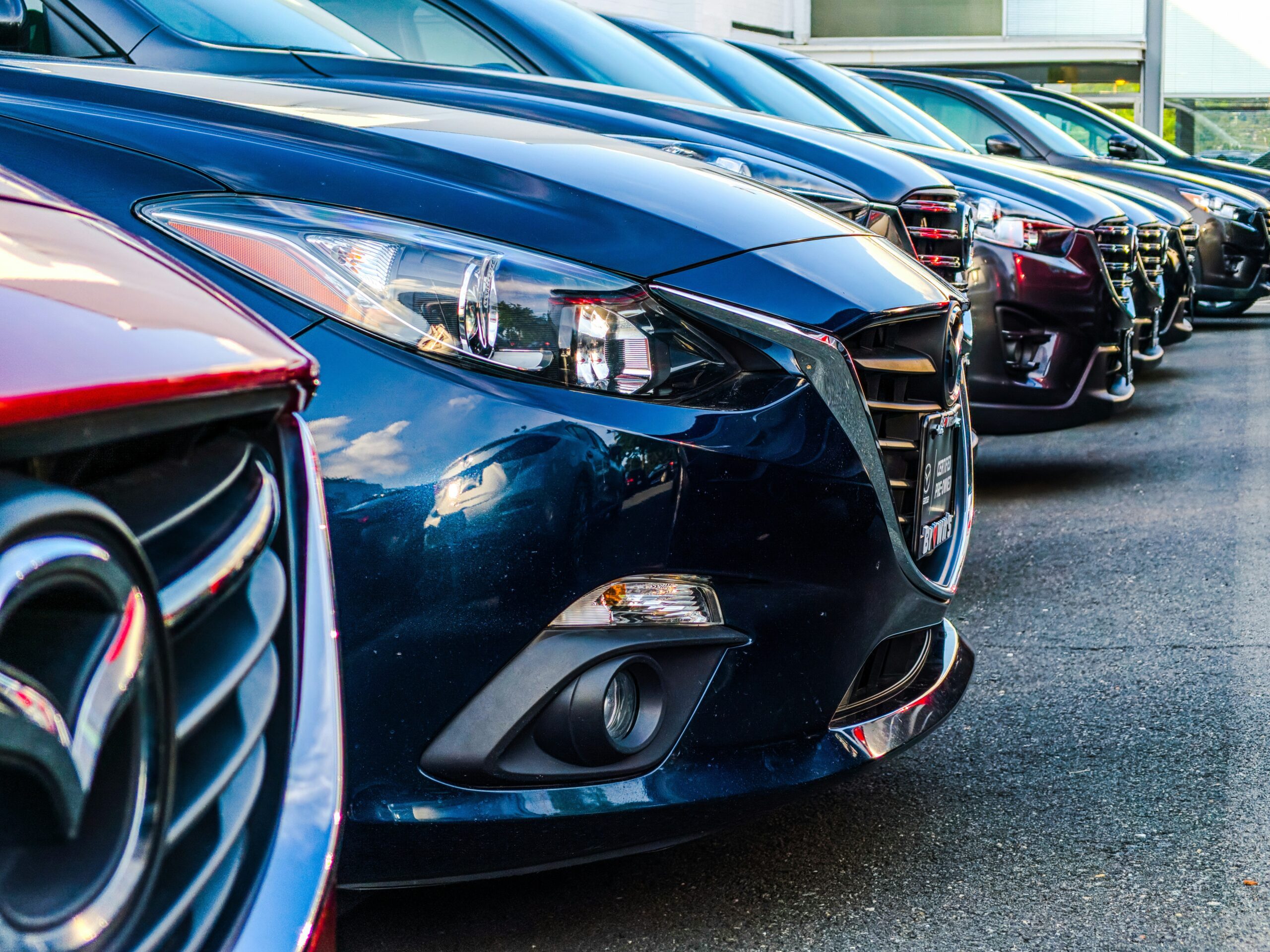 Side view of multiple cars in a row on a parking lot